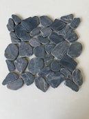 Black 11x11 natural stone pebble mosaic tile for wall installation by Roca, showing textured pebble surface and mosaic pattern.