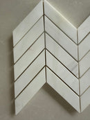 Dolomite chevron marble mosaic installed as a sophisticated kitchen backsplash