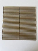 Lux Bronze 12x12 flutted glass mosaic tile for wall installation by Roca, showcasing textured bronze glass surface.