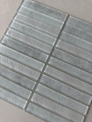 Lux Harbor 12x12 stacked glass mosaic tile wall tile by Roca featuring a sleek, textured dune-colored glass backsplash design.