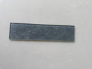 LUX Pewter 3x12 glass tile installed on a sophisticated interior feature wall
