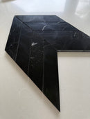 Polished black marble chevron mosaic tile installed as a luxury kitchen backsplash