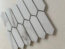 Close up of polished Calacatta marble picket mosaic tile showing natural veining and glossy surface