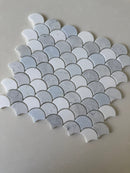Roca Rockart Blue Mix Carrara Thassos fan-shaped mosaic tile for shower wall, featuring natural stone with blue, white, and gray tones.