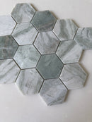 Green marble hexagon mosaic tile by Roca featuring natural stone texture and intricate pattern, perfect for elegant shower designs.