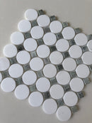 Natural stone tile mosaic featuring green mix Thassos circles by Roca, 12x12 inches, shown as a backsplash with circular pattern.